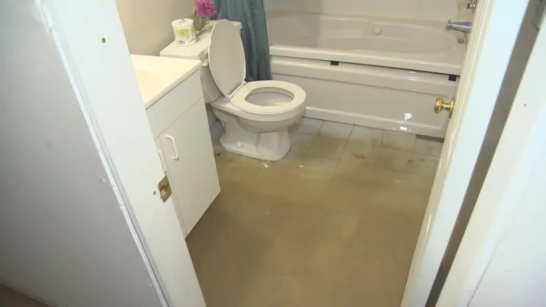 Bathroom floor affected by standing water from a water damage incident in Everett, WA